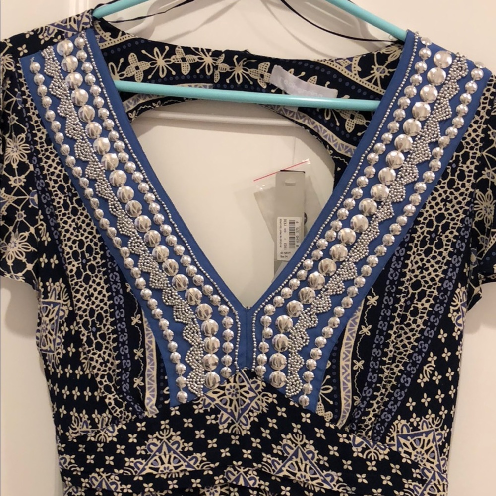 Printed dress with hand stitched embellishments.